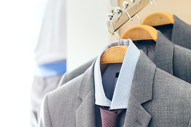 three suits on hangers