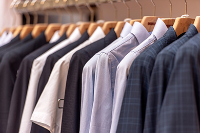 shirts and suit jackets on wooden hangers