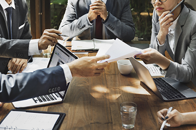 business meeting showing laptops and documents