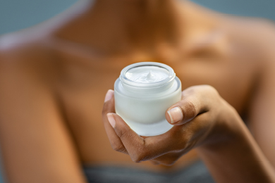 woman holding jar of cream